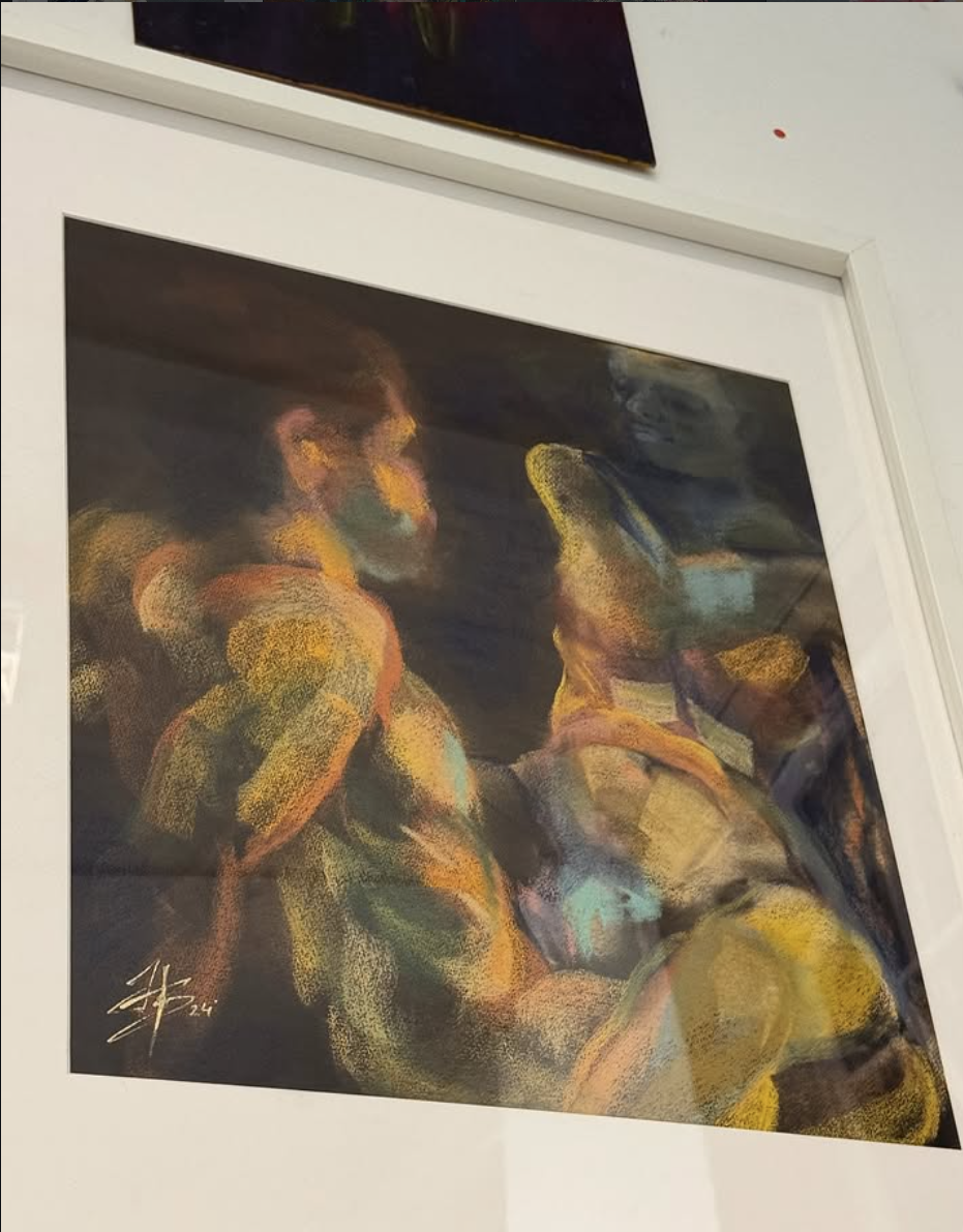 Pictures showing an exhibited work at the group exhibition organised by Daniel Schmude. The work features two figures drawn from life in soft pastel by artist Bogdan Jensen. 