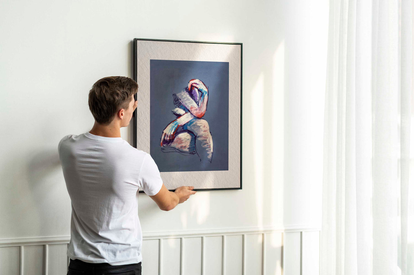 A Gentle Touch fine art print by Bogdan Jensen displayed on a bedroom floor, showing the soft pastel seated figure in a relaxed interior setting