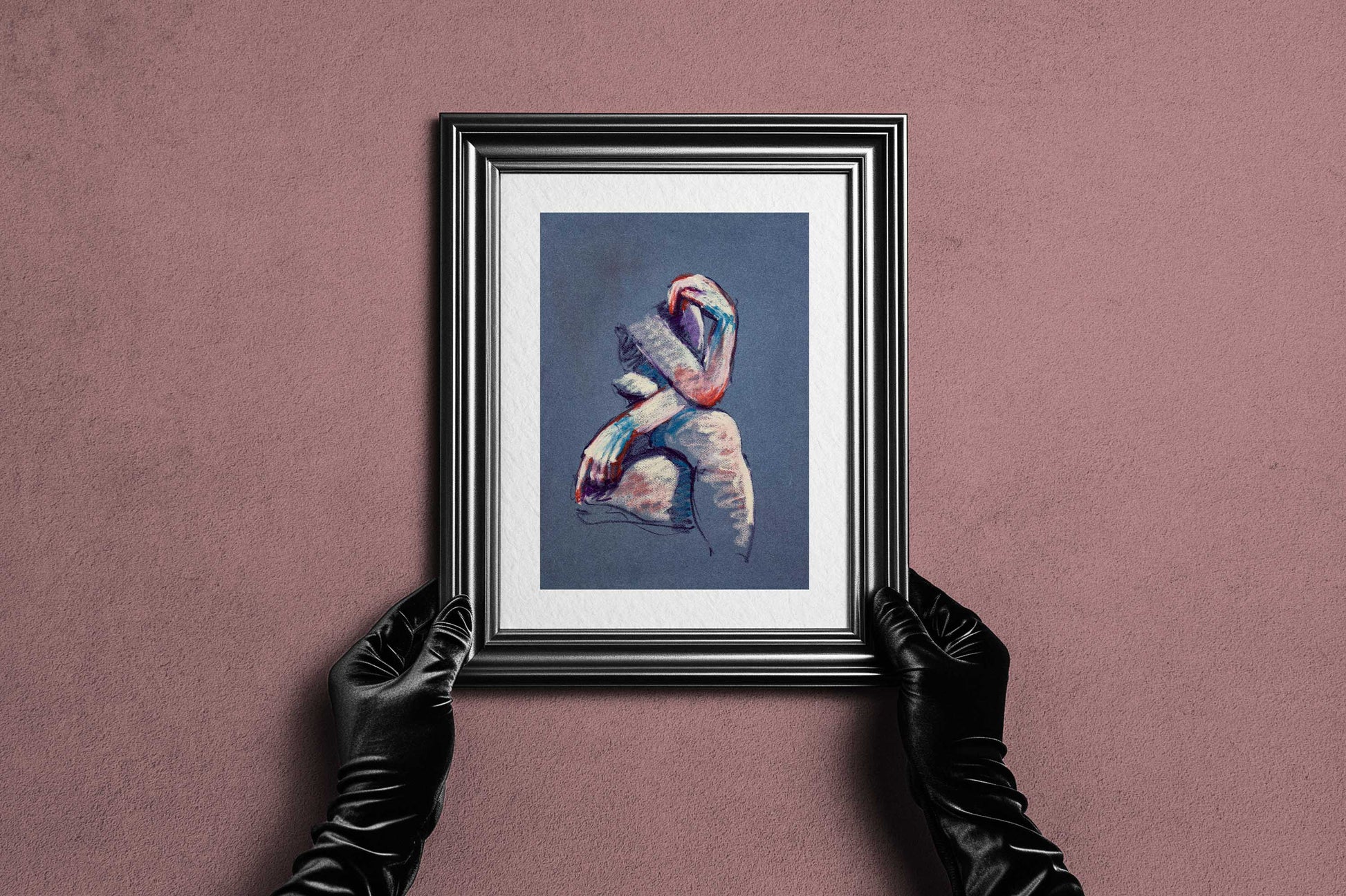 Framed A Gentle Touch fine art print by Bogdan Jensen held by hands, showing the soft pastel seated figure in a dark frame
