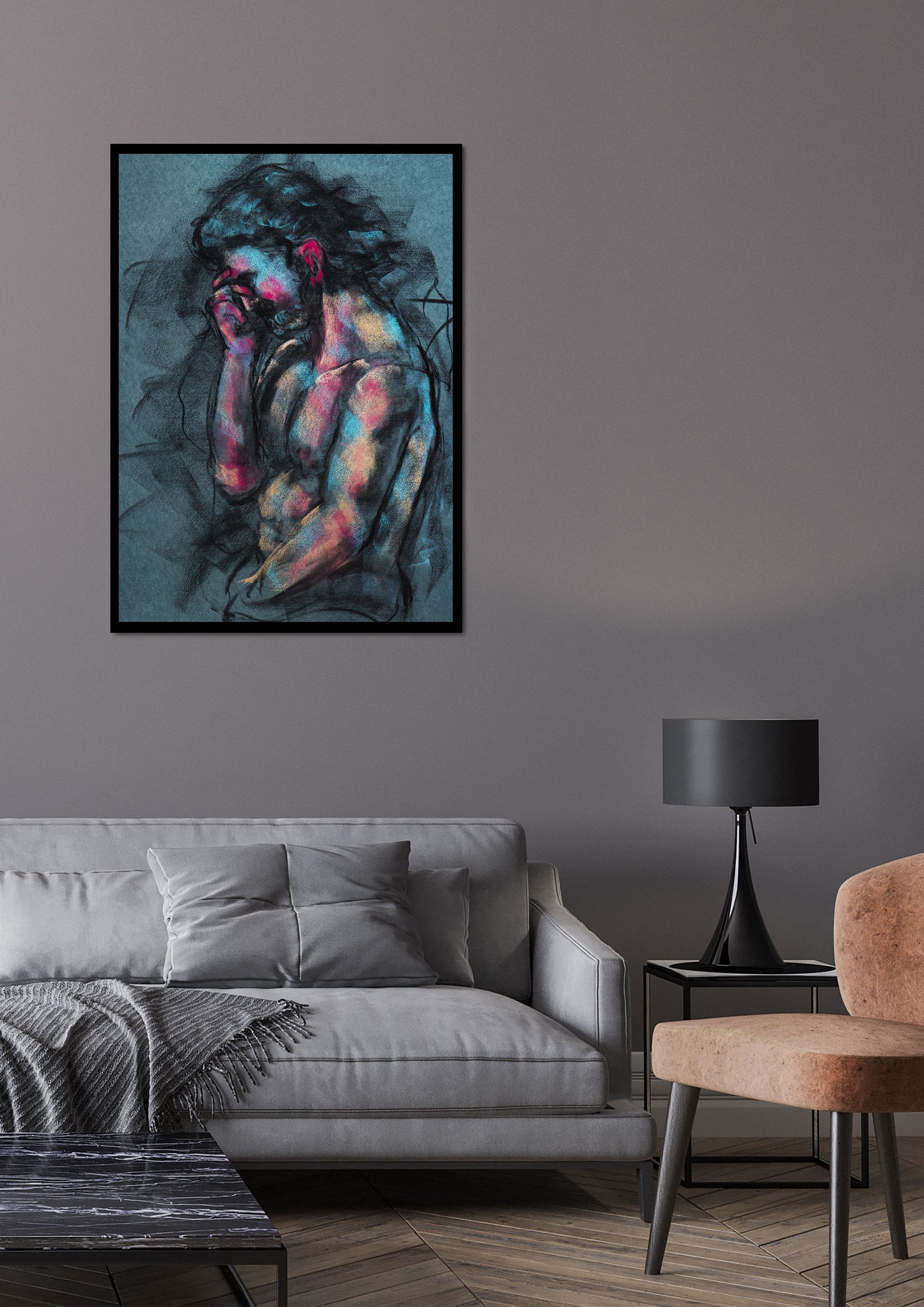 A Quiet Ache fine art print by Bogdan Jensen shown framed above a grey sofa in a modern living room, featuring a charcoal figure drawing with blue and rose highlights