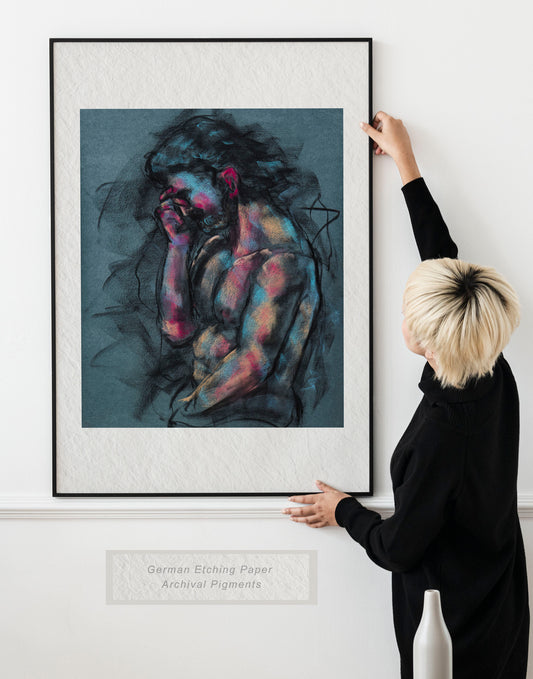 Woman holding framed A Quiet Ache fine art print by Bogdan Jensen on a wall, showing the seated figure drawing with blue and rose highlights in a bright interior