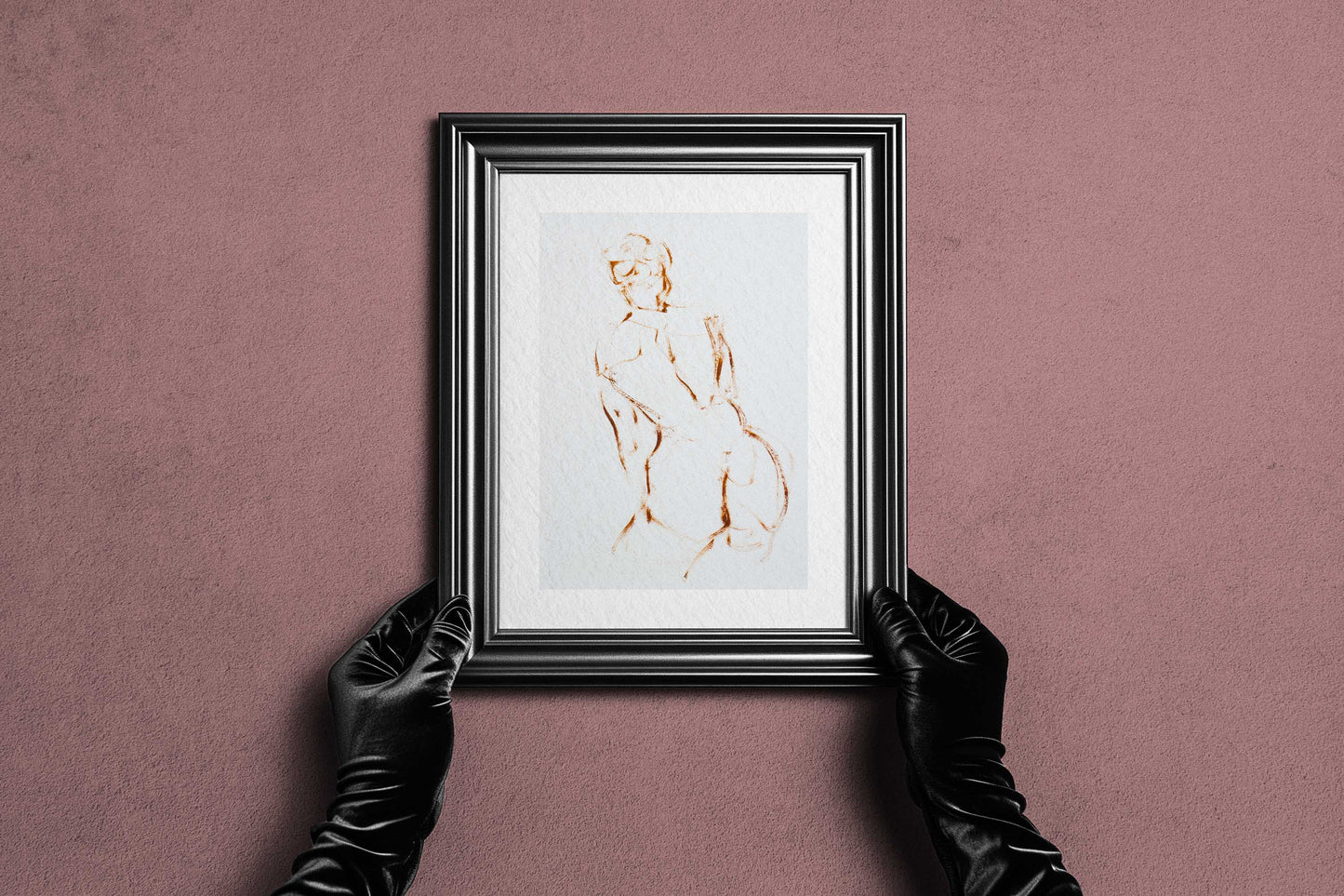 Framed A Shape I Almost Knew fine art print by Bogdan Jensen held by hands, showing the minimal figure drawing in a dark frame