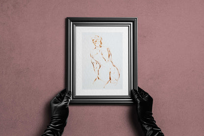 Framed A Shape I Almost Knew fine art print by Bogdan Jensen held by hands, showing the minimal figure drawing in a dark frame
