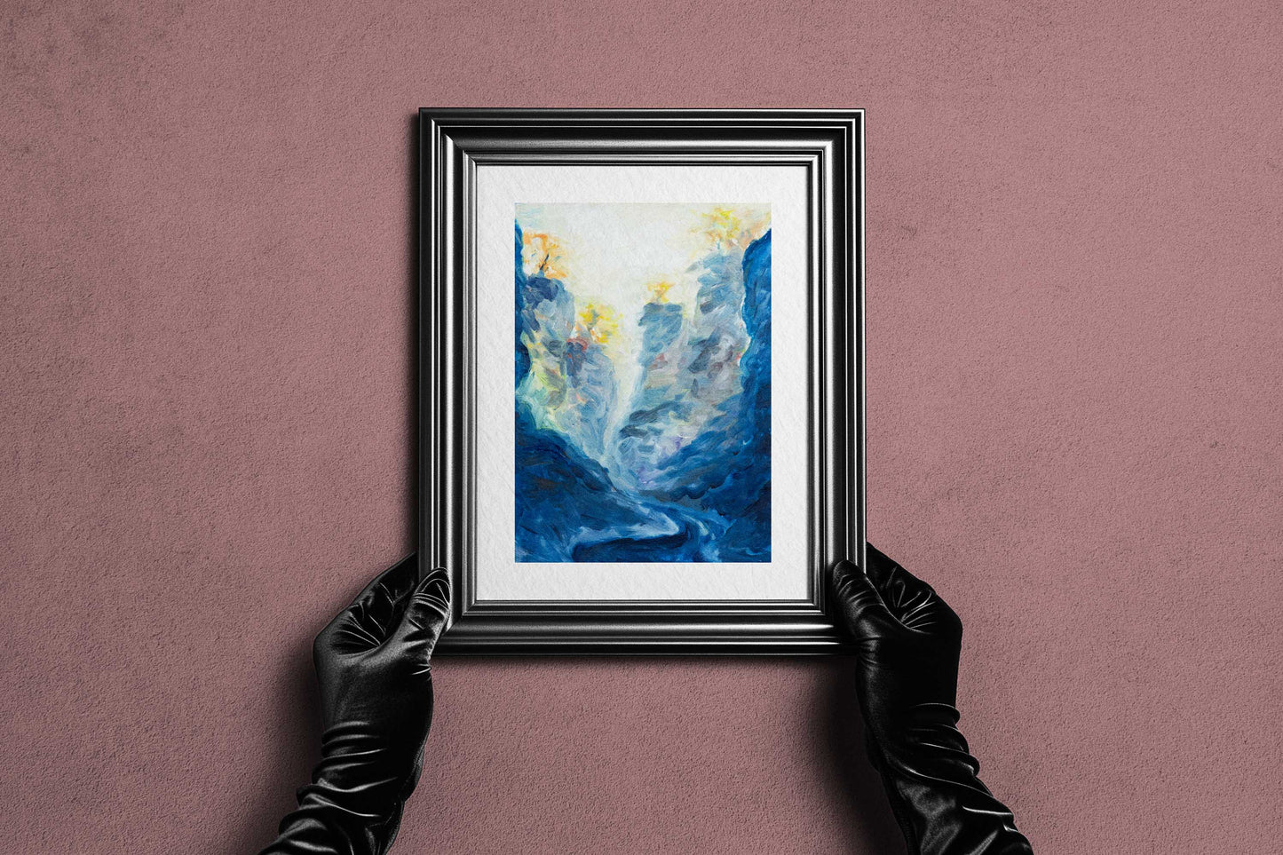 Framed Blue Passage fine art print by Bogdan Jensen held by hands, showing the blue-toned original painting in a dark frame