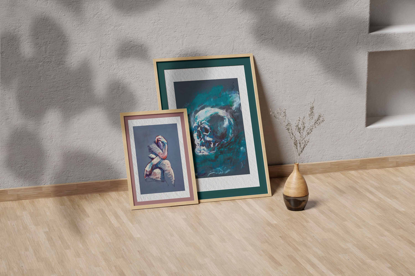 Blue Remains fine art print by Bogdan Jensen shown leaning in a floor frame, with the blue-toned skull study beside a smaller framed artwork