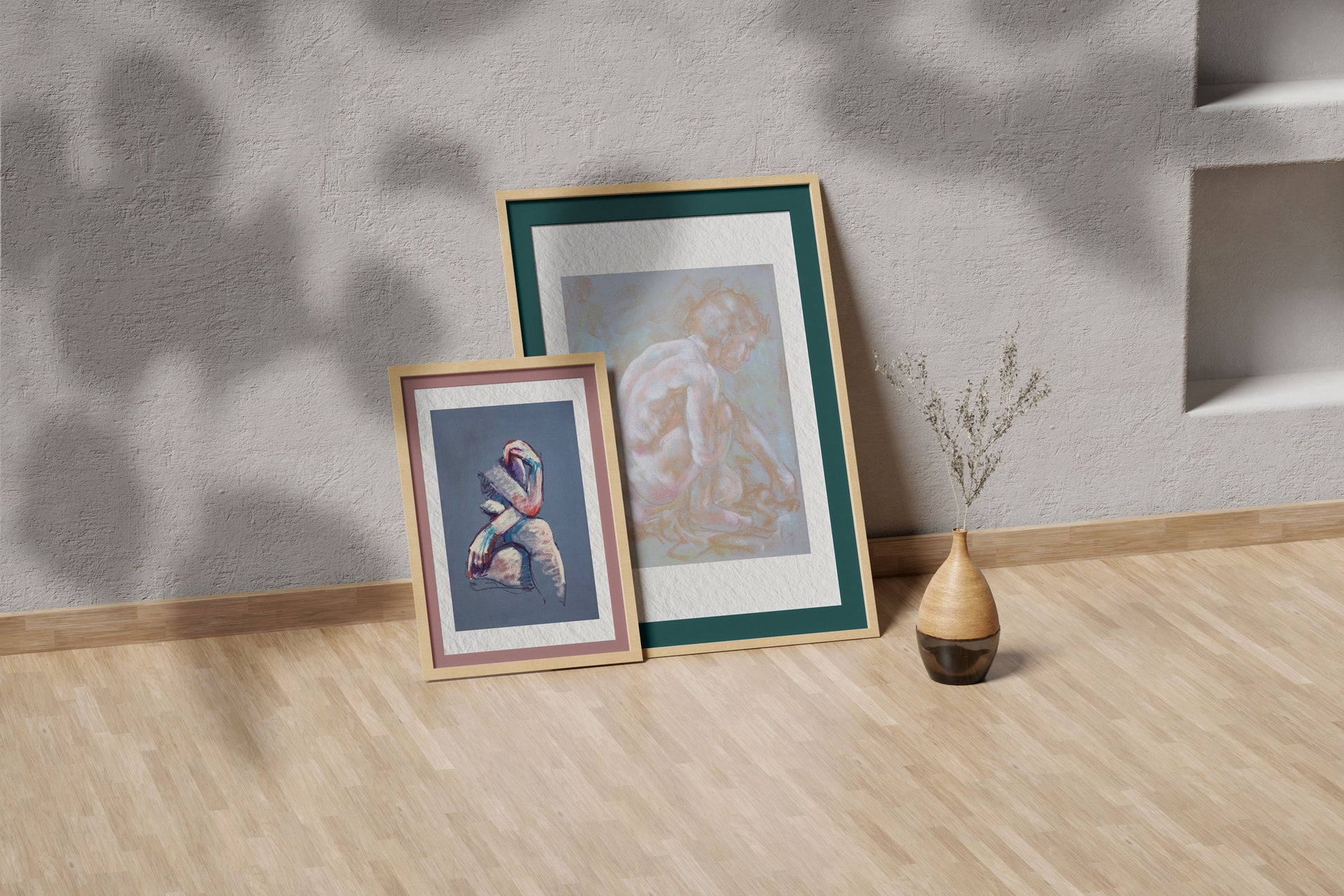 Inner Stillness fine art print by Bogdan Jensen shown leaning in a floor frame, with the pale crouched figure study beside a smaller framed artwork