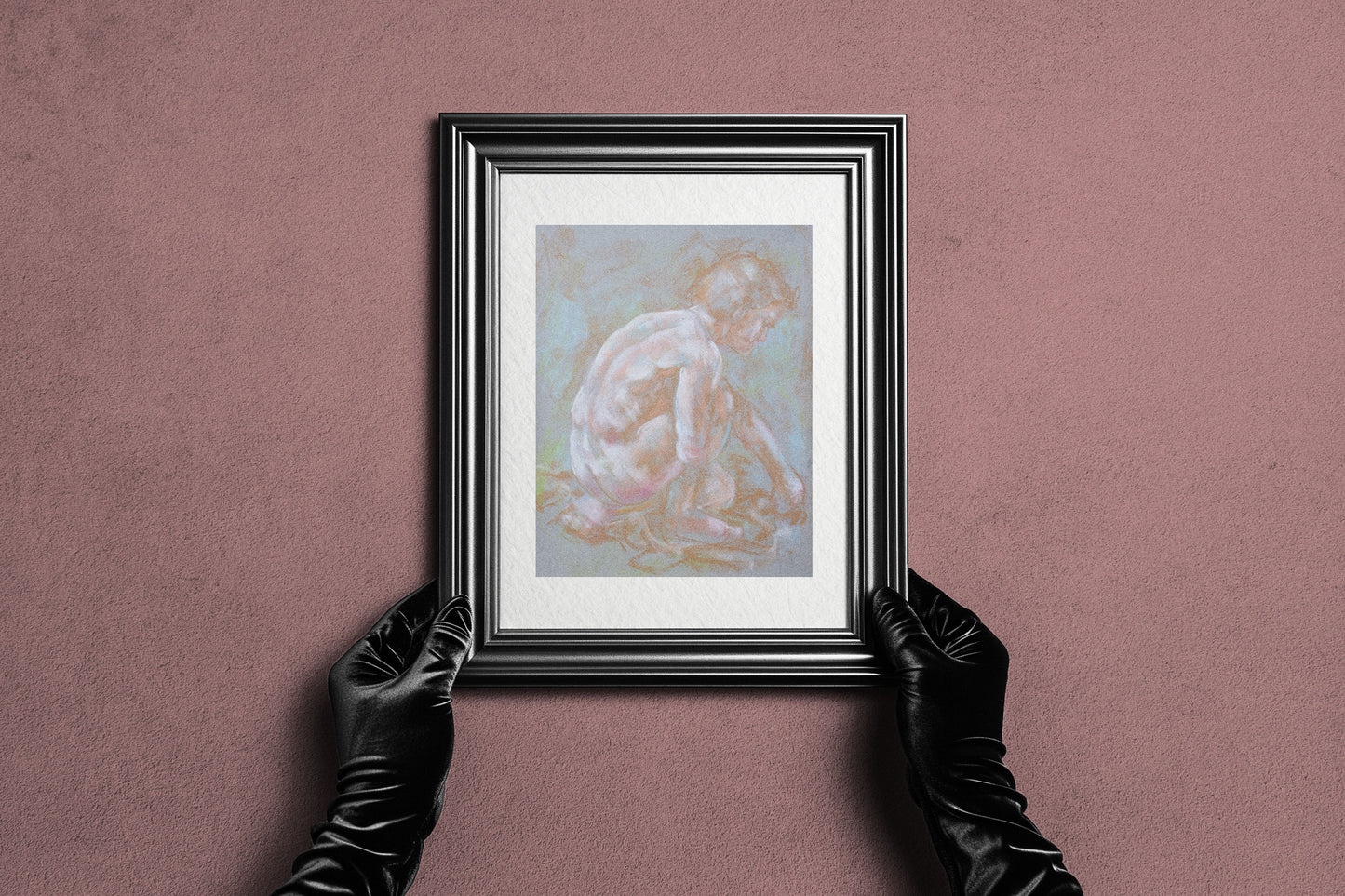Framed Inner Stillness fine art print by Bogdan Jensen held by hands, showing the pale soft pastel figure study in a dark frame