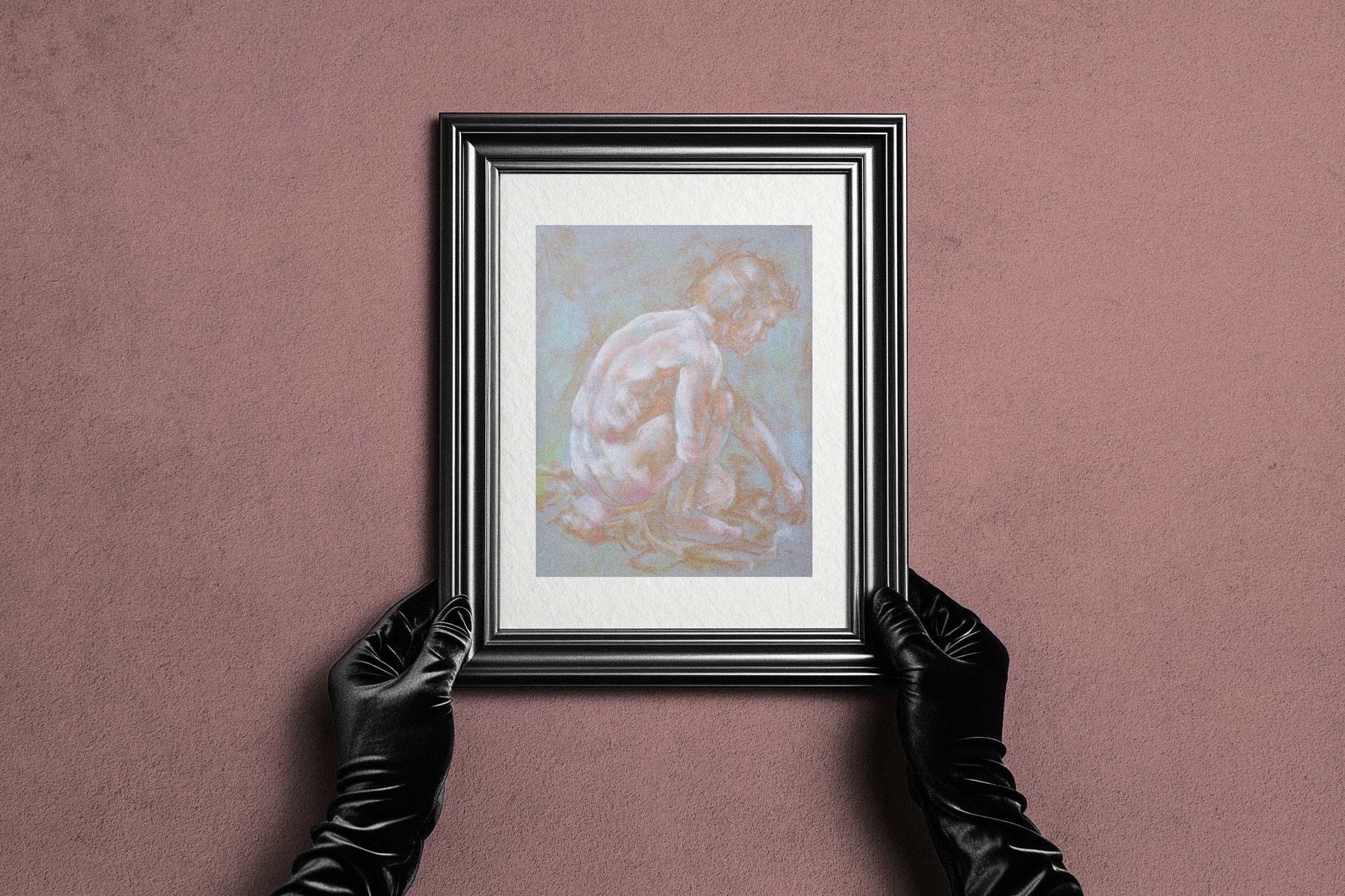 Framed Inner Stillness fine art print by Bogdan Jensen held by hands, showing the pale soft pastel figure study in a dark frame