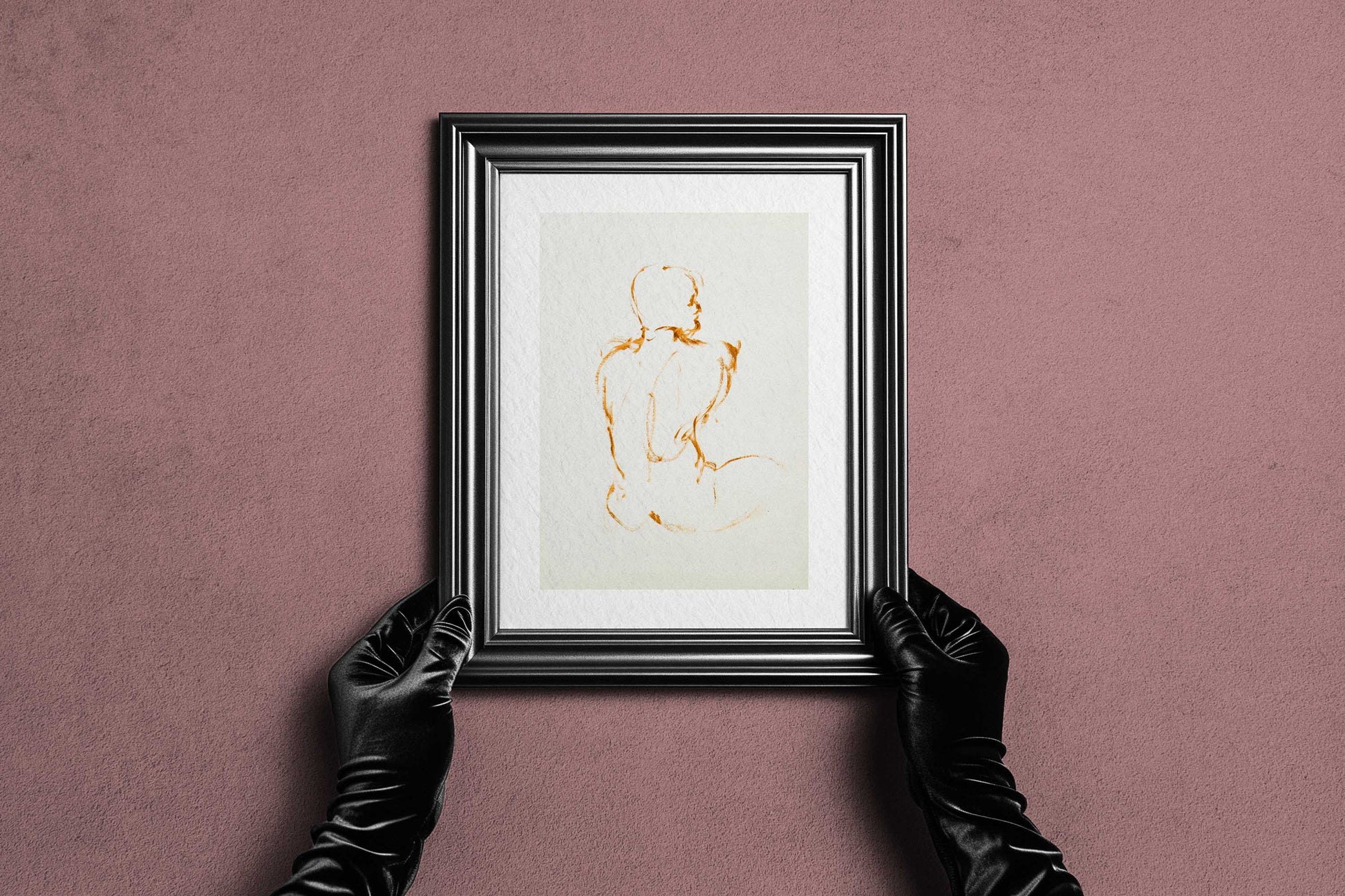 Framed Lost in Line fine art print by Bogdan Jensen held by hands, showing the spare ochre figure drawing in a dark frame
