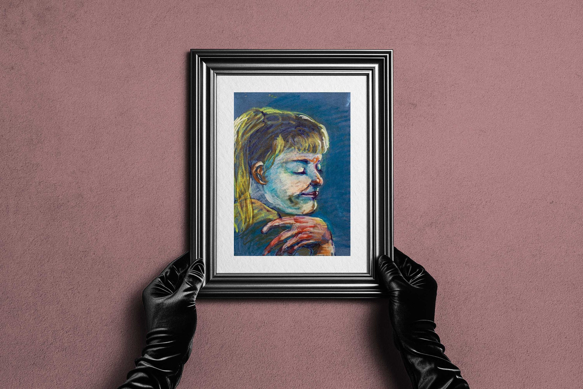 Framed Quiet Tide fine art print by Bogdan Jensen held by hands, showing the blue-toned pastel portrait in a dark frame