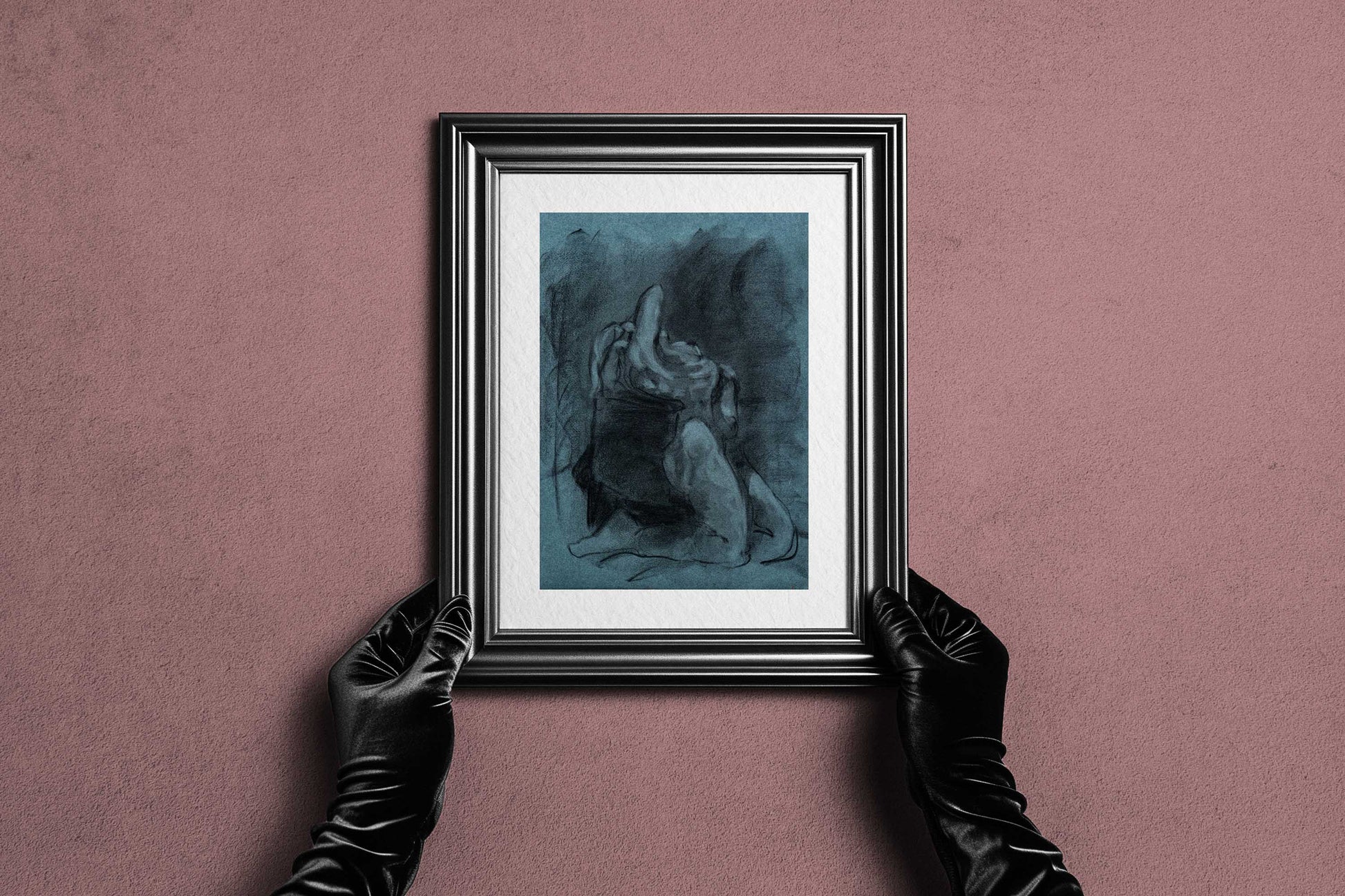 Framed Returned from Shadow fine art print by Bogdan Jensen held by hands, showing the blue-toned charcoal figure drawing in a dark frame