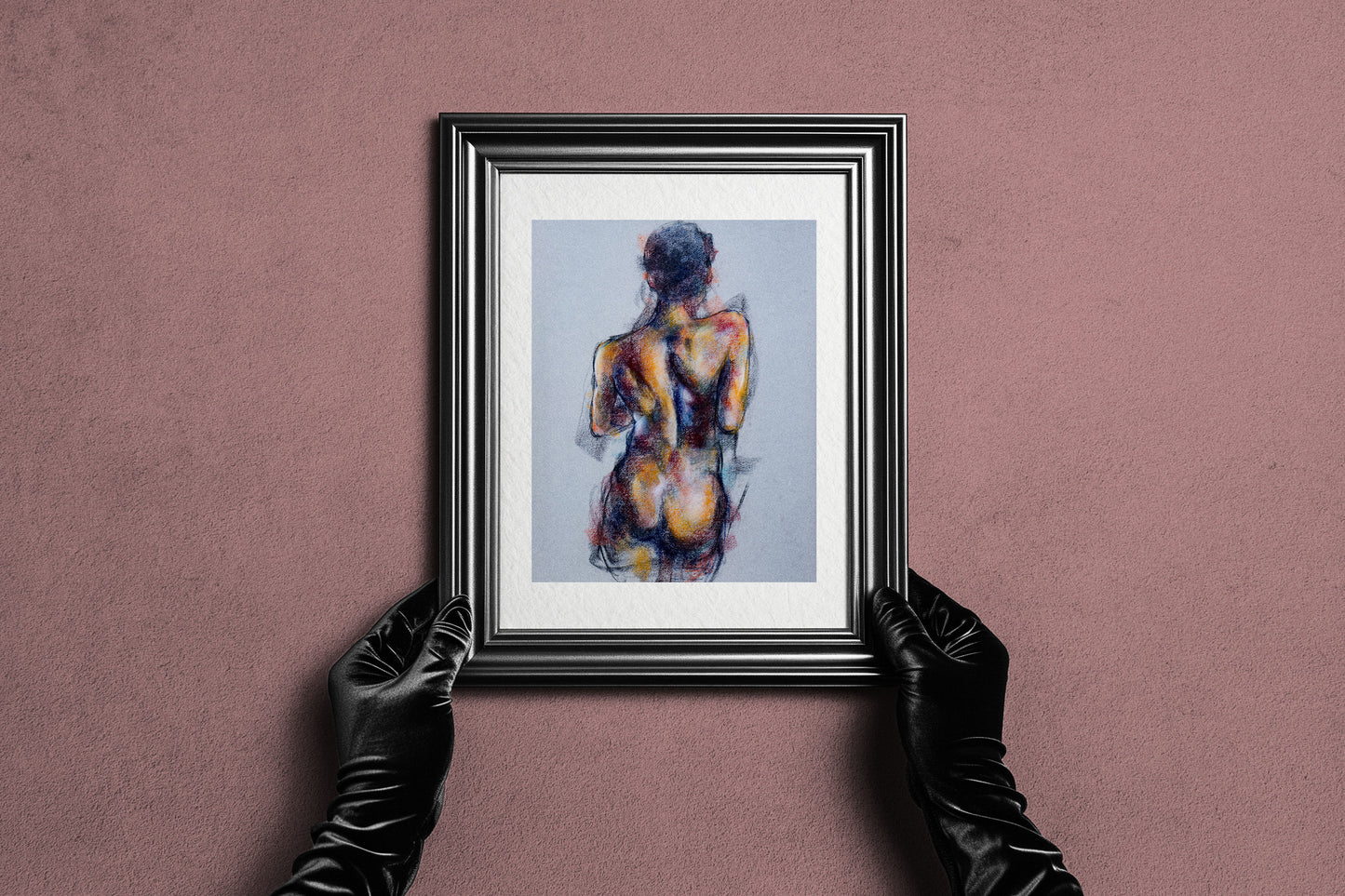 Framed Where the Dance Lives fine art print by Bogdan Jensen held by hands, showing the pastel figure study in a dark frame
